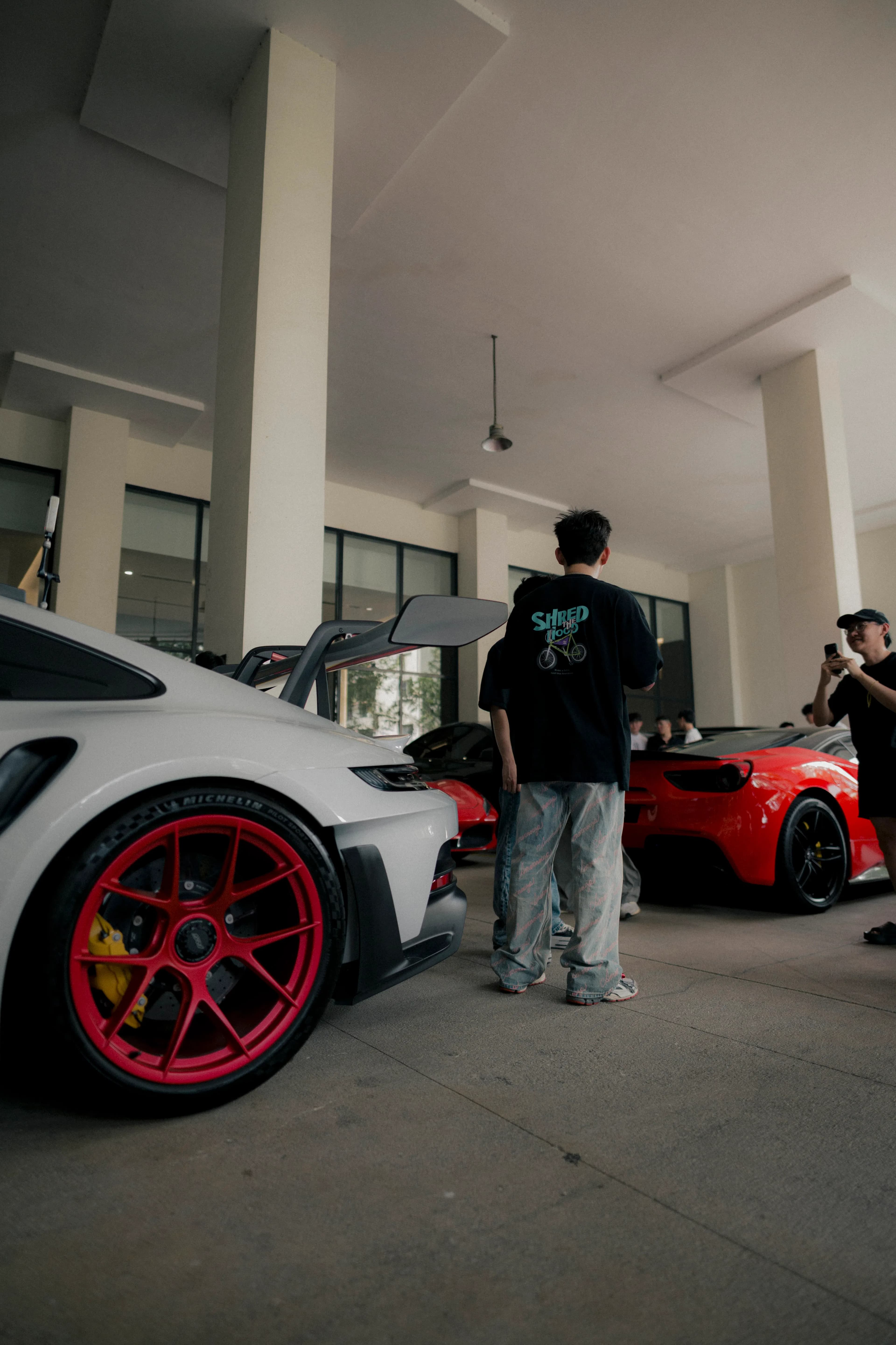 White Porsche GT3 RS with red wheels in the D&Dream showroom