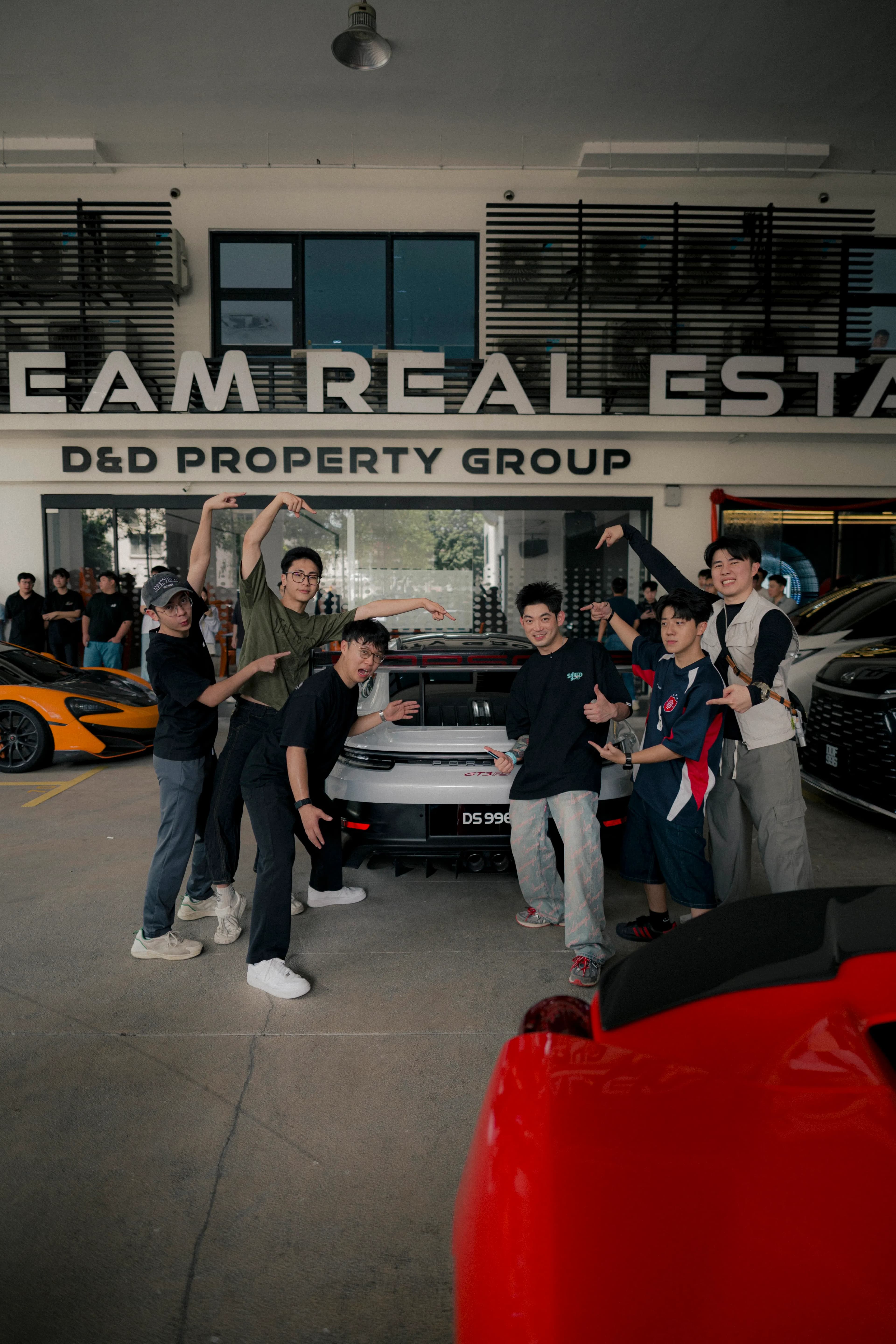 Friends gathered behind the GT3 RS outside D&D Property Group