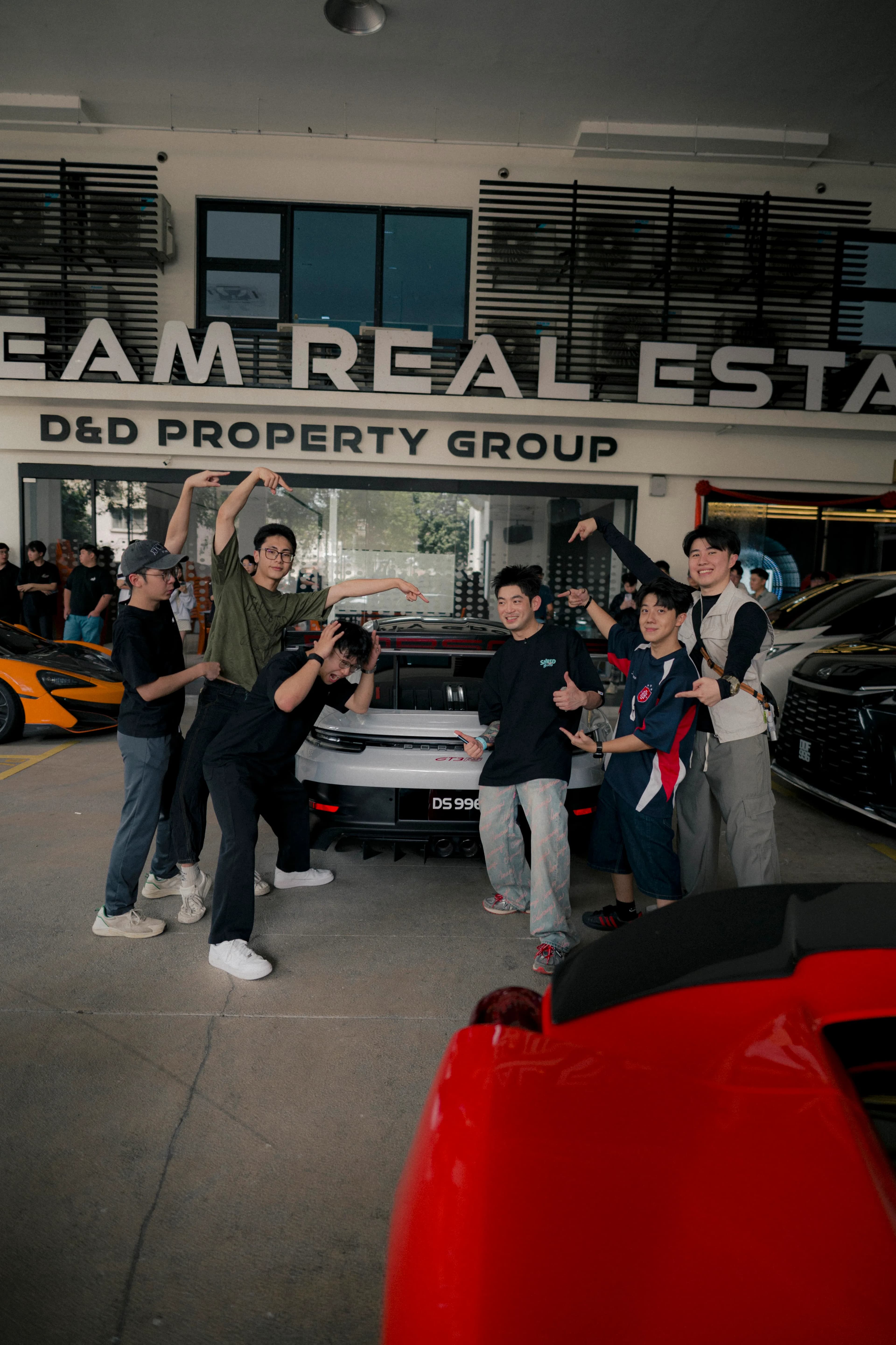 Playful group pose around the white GT3 RS